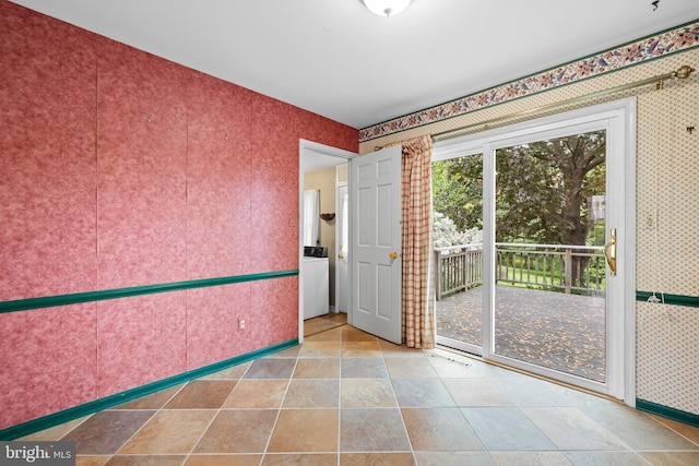 spare room featuring wallpapered walls