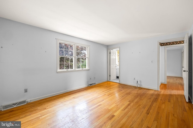 empty room with light wood-type flooring and baseboards