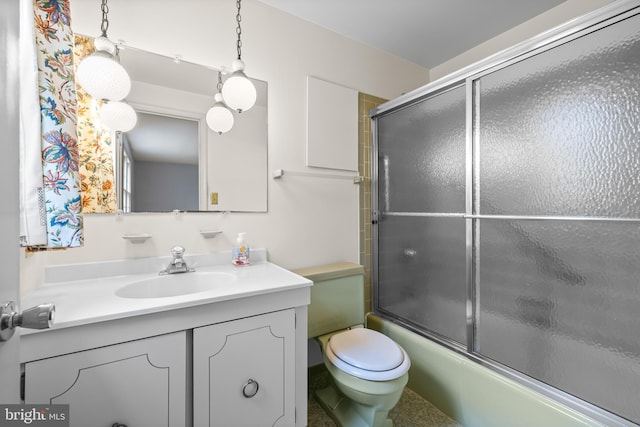 bathroom featuring vanity, bath / shower combo with glass door, and toilet