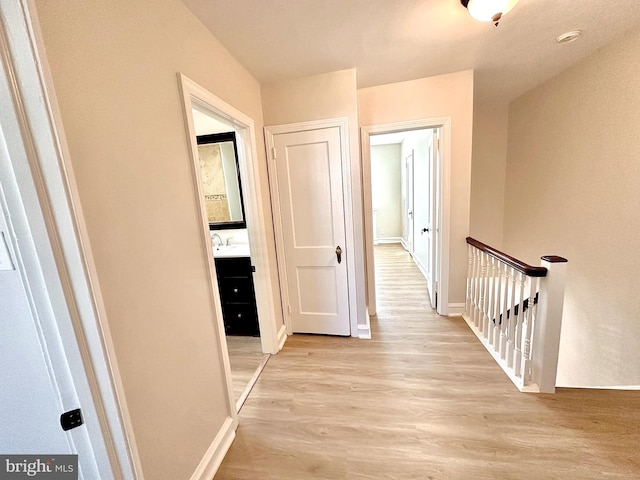 442 E Slocum St, Philadelphia, PA 19119 - hallway with an upstairs landing, light wood-style floors, baseboards, and a sink