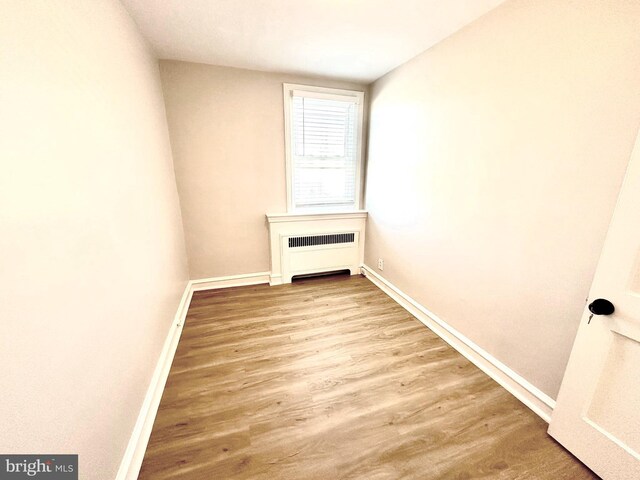 442 E Slocum St, Philadelphia, PA 19119 - empty room featuring radiator, baseboards, and wood finished floors