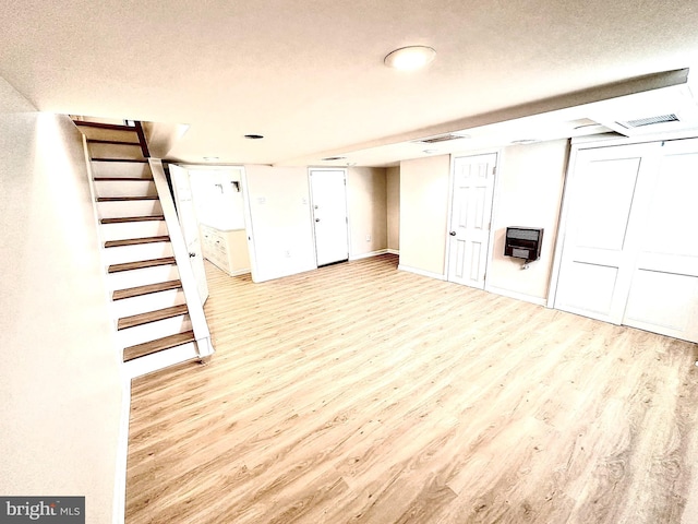 442 E Slocum St, Philadelphia, PA 19119 - finished below grade area featuring light wood finished floors, heating unit, stairs, a textured ceiling, and baseboards