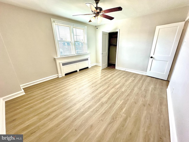 442 E Slocum St, Philadelphia, PA 19119 - unfurnished bedroom with radiator heating unit, wood finished floors, baseboards, and a ceiling fan