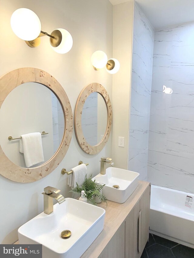 full bathroom featuring a sink, tile patterned flooring, and shower / washtub combination
