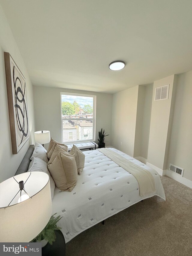 carpeted bedroom featuring baseboards