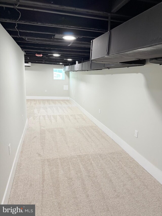 basement with carpet flooring and baseboards