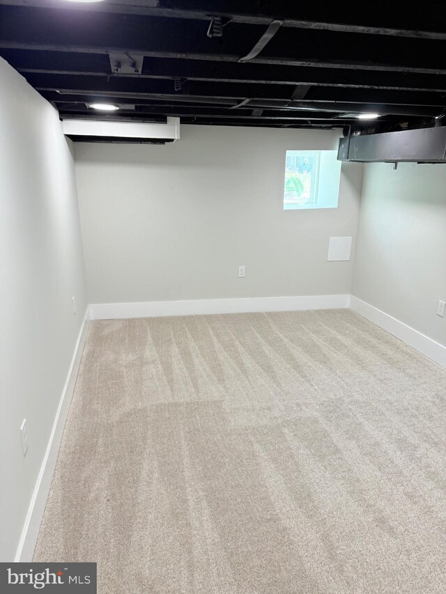 basement with carpet flooring and baseboards