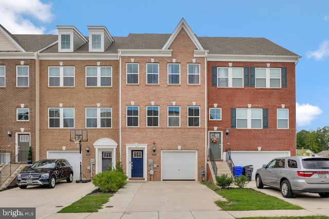 5753 Frederick Douglas Pl, White Plains, MD 20695 - townhome / multi-family property with driveway, an attached garage, and brick siding