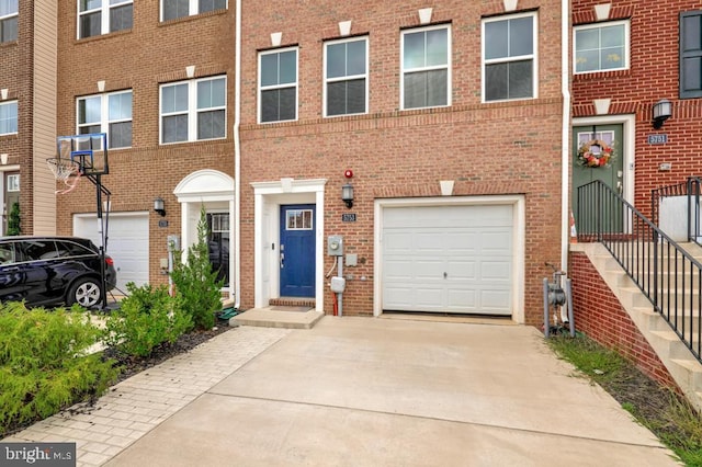 5753 Frederick Douglas Pl, White Plains, MD 20695 - view of front facade featuring an attached garage, concrete driveway, and brick siding