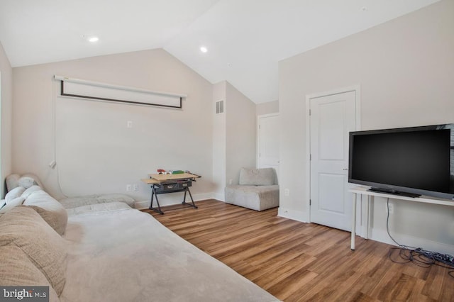 5753 Frederick Douglas Pl, White Plains, MD 20695 - living area featuring lofted ceiling, wood finished floors, and baseboards
