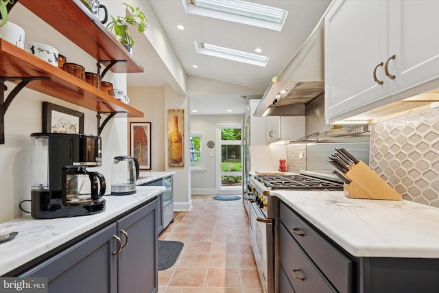 214 E Willow Grove Ave, Philadelphia, PA 19118 - kitchen with high end stainless steel range, a skylight, under cabinet range hood, backsplash, and recessed lighting