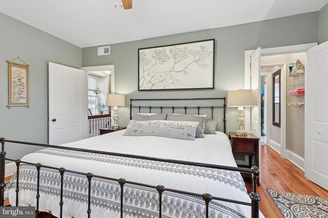 214 E Willow Grove Ave, Philadelphia, PA 19118 - bedroom with wood finished floors, baseboards, and a ceiling fan
