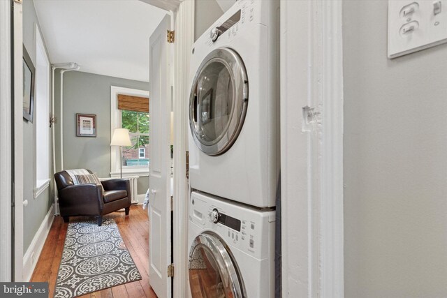 214 E Willow Grove Ave, Philadelphia, PA 19118 - laundry room with estacked washer and dryer, wood finished floors, and baseboards