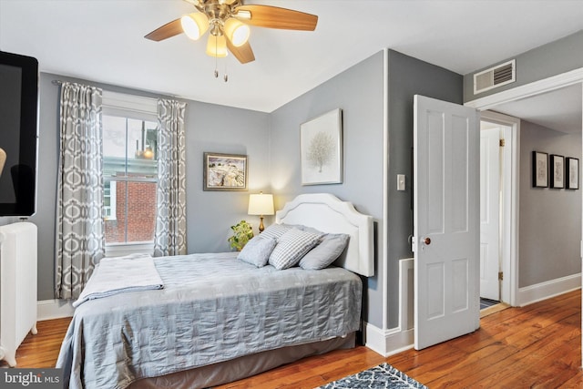 214 E Willow Grove Ave, Philadelphia, PA 19118 - bedroom with radiator heating unit, wood finished floors, baseboards, and ceiling fan