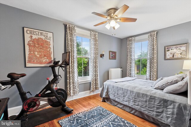 214 E Willow Grove Ave, Philadelphia, PA 19118 - bedroom with radiator heating unit, wood finished floors, baseboards, and ceiling fan