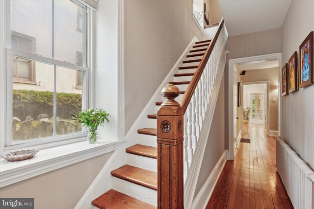 214 E Willow Grove Ave, Philadelphia, PA 19118 - stairs with radiator, hardwood / wood-style floors, plenty of natural light, and baseboards