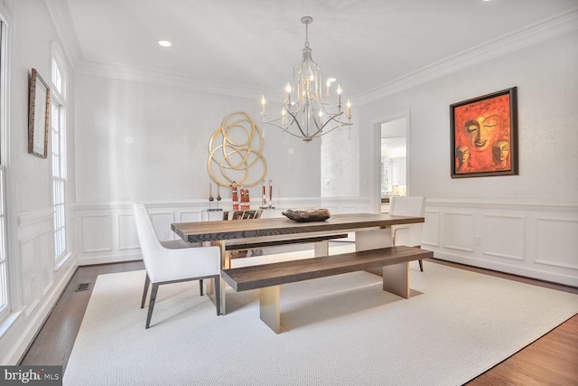 7845 Montvale Way, Mclean, VA 22102 - dining room featuring a chandelier, crown molding, wood finished floors, plenty of natural light, and a decorative wall