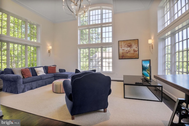 7845 Montvale Way, Mclean, VA 22102 - living area with a high ceiling, healthy amount of natural light, a chandelier, and wood finished floors