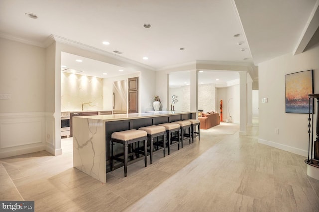 7845 Montvale Way, Mclean, VA 22102 - bar featuring crown molding, recessed lighting, light wood-type flooring, white oven, and decorative columns
