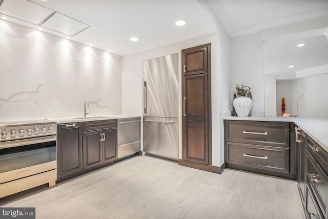 7845 Montvale Way, Mclean, VA 22102 - kitchen featuring appliances with stainless steel finishes, a sink, ornamental molding, dark brown cabinets, and backsplash