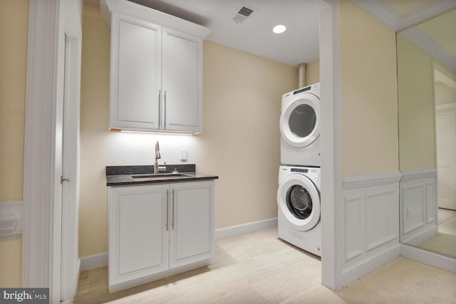 7845 Montvale Way, Mclean, VA 22102 - laundry area featuring stacked washer and clothes dryer, cabinet space, and baseboards