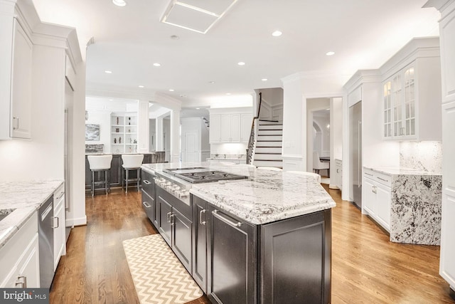 7845 Montvale Way, Mclean, VA 22102 - kitchen with stainless steel appliances, white cabinets, tasteful backsplash, light wood-style floors, and recessed lighting