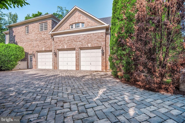 7845 Montvale Way, Mclean, VA 22102 - garage featuring decorative driveway and fence