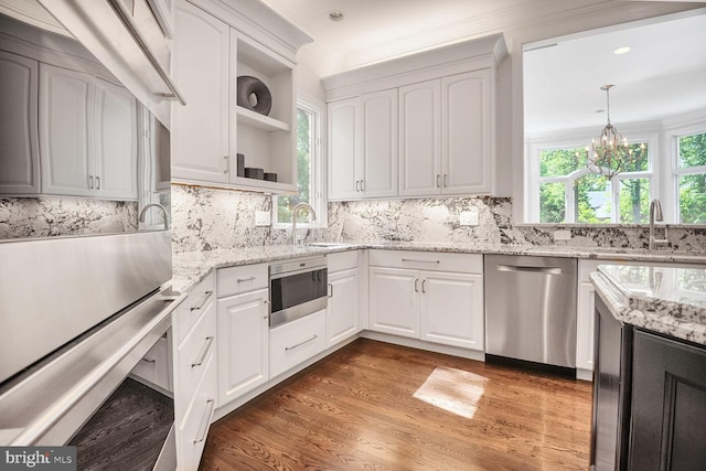 7845 Montvale Way, Mclean, VA 22102 - kitchen with appliances with stainless steel finishes, a sink, wood finished floors, white cabinets, and a chandelier
