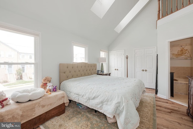 6005 Southward Way, Alexandria, VA 22315 - bedroom with a skylight, two closets, high vaulted ceiling, and wood finished floors