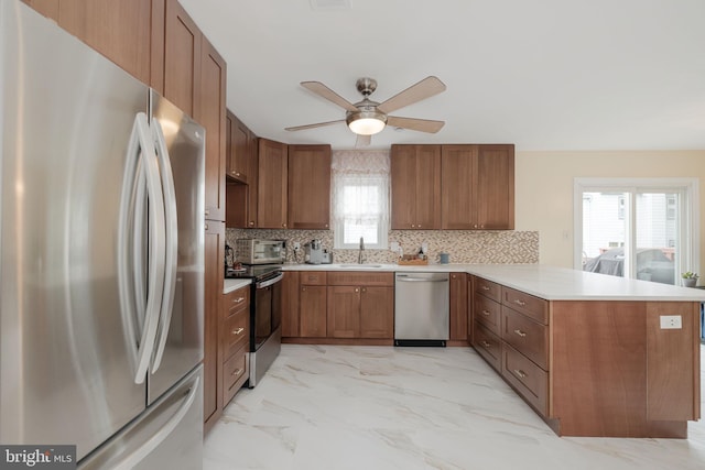 6005 Southward Way, Alexandria, VA 22315 - kitchen with appliances with stainless steel finishes, a peninsula, ceiling fan, and brown cabinets