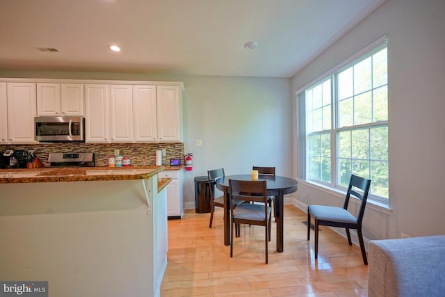 36 Crows Nest Ct, Mount Laurel, NJ 08054 - kitchen with appliances with stainless steel finishes, decorative backsplash, white cabinetry, light wood-style flooring, and baseboards