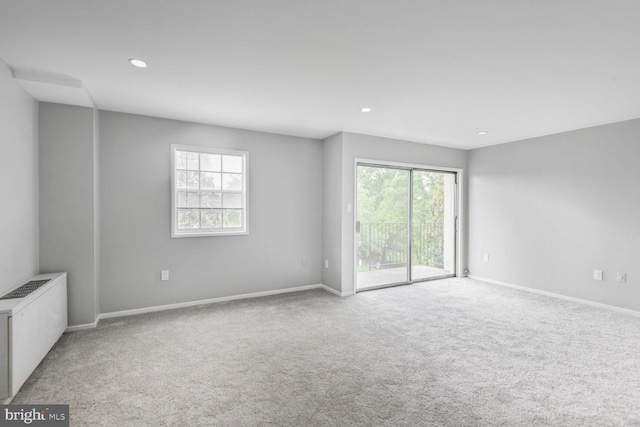4425 Romlon St Unit 103, Beltsville, MD 20705 - empty room with light colored carpet, radiator, baseboards, and recessed lighting
