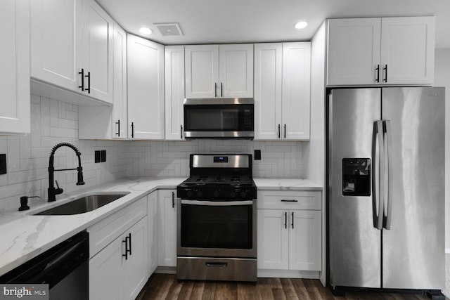 4425 Romlon St Unit 103, Beltsville, MD 20705 - kitchen featuring appliances with stainless steel finishes, a sink, white cabinetry, and recessed lighting