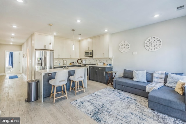2812 Georgia Ave NW Unit 6, Washington, DC 20001 - living area featuring light wood-type flooring and recessed lighting