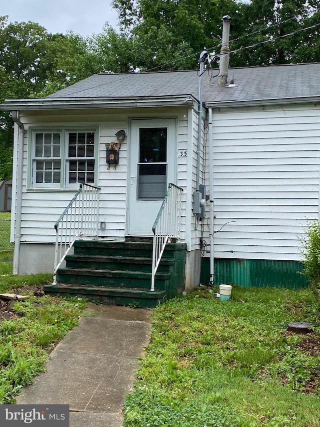 view of front of property featuring entry steps and roof with shingles