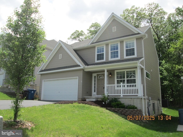 view of front of property with a porch, concrete driveway, a front lawn, and central AC unit