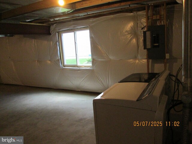 below grade area featuring washer / clothes dryer and electric panel