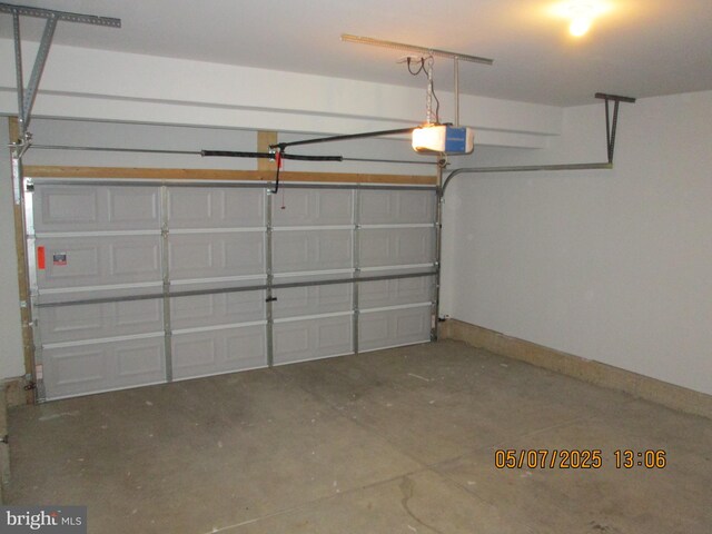 garage with a garage door opener and baseboards