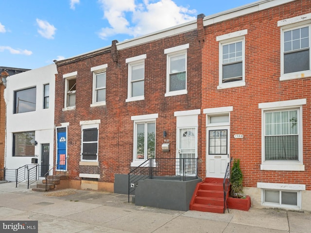 view of property featuring brick siding
