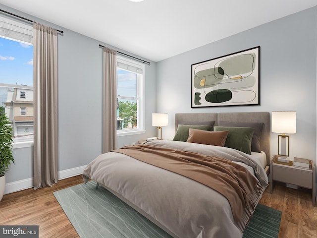 bedroom featuring wood finished floors and baseboards