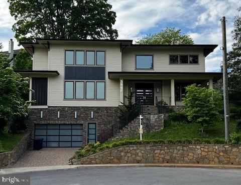 3546 N Utah St, Arlington, VA 22207 - view of front of property with stone siding, driveway, and a garage