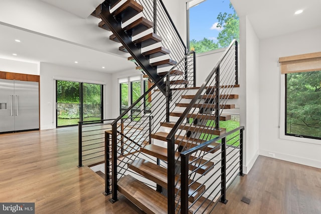 3546 N Utah St, Arlington, VA 22207 - stairs with wood finished floors, baseboards, and recessed lighting