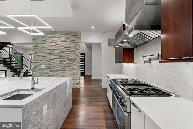 3546 N Utah St, Arlington, VA 22207 - kitchen with a sink, double oven range, wall chimney exhaust hood, tasteful backsplash, and dark wood-type flooring
