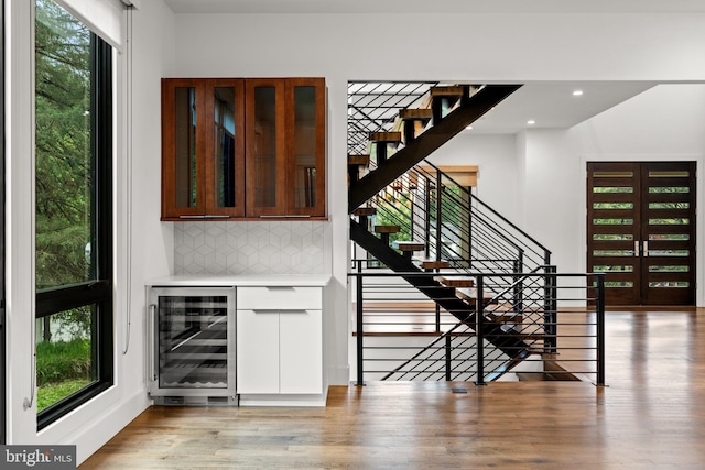 3546 N Utah St, Arlington, VA 22207 - indoor dry bar with wine cooler, decorative backsplash, light wood-style flooring, stairway, and recessed lighting