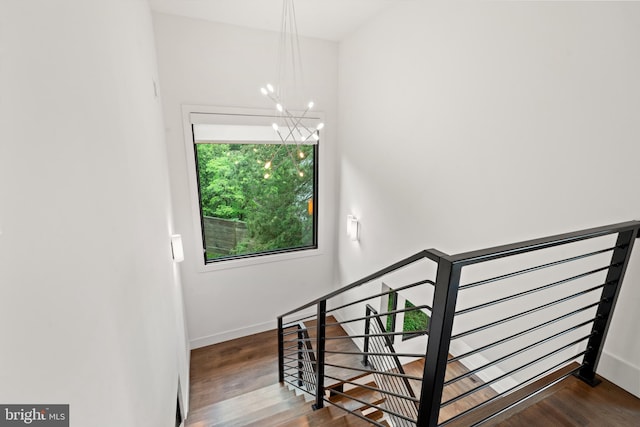 3546 N Utah St, Arlington, VA 22207 - stairs with a chandelier, wood finished floors, and baseboards