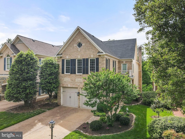 view of front of property featuring concrete driveway, brick siding, a garage, and roof with shingles