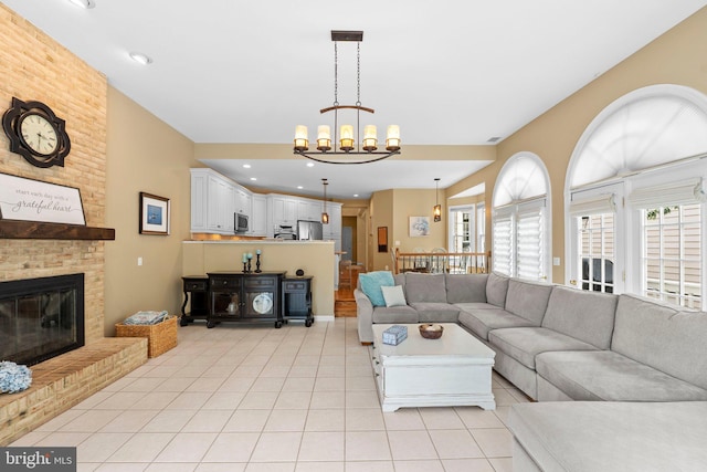 living room with light tile patterned floors, a chandelier, a fireplace, and recessed lighting