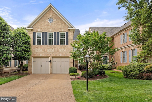view of front of house featuring brick siding, driveway, a garage, and a front lawn