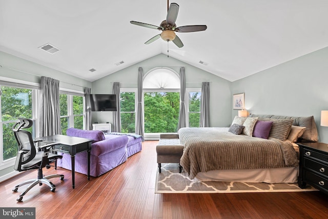 bedroom with vaulted ceiling, a ceiling fan, wood finished floors, and a desk