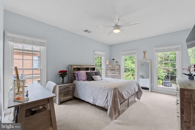 bedroom featuring light colored carpet, access to outside, and a ceiling fan